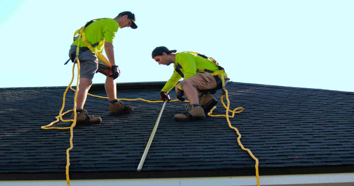 two guys working on a roof